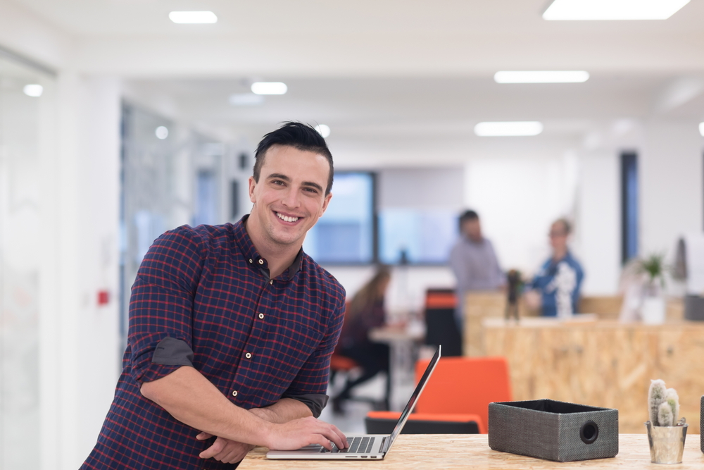 portrait of young businessman in casual clothes at modern  startup business office space,  working on laptop  computer-2